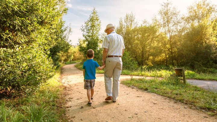 grandfather-and-grandchild-walking-outdoors-2021-08-31-11-01-23-utc