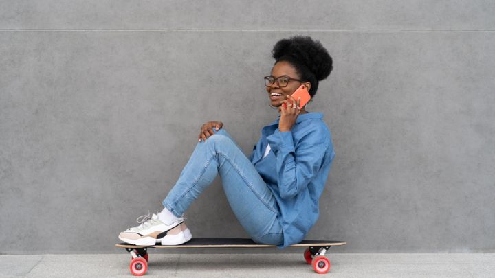 happy-trendy-black-girl-talk-on-phone-stylish-afr-2021-09-04-05-02-53-utc